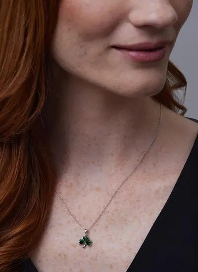 Close up of red haired model wearing Sterling Silver Shamrock Celtic Pendant with Green Cubic Zirconia